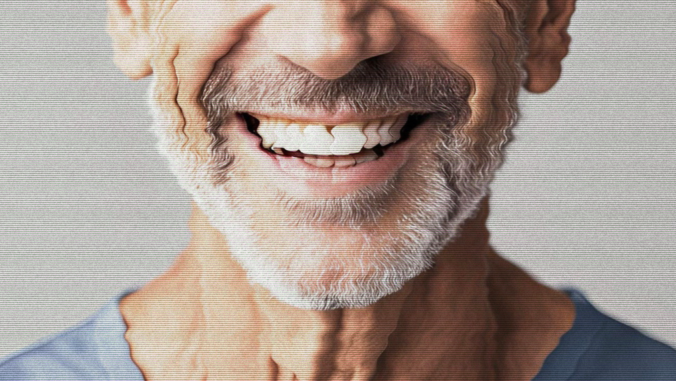 A close-up of a smiling older mans mouth and beard. The image has a distorted, wavy effect creating a surreal appearance. The man has a white beard and is wearing a light blue shirt.